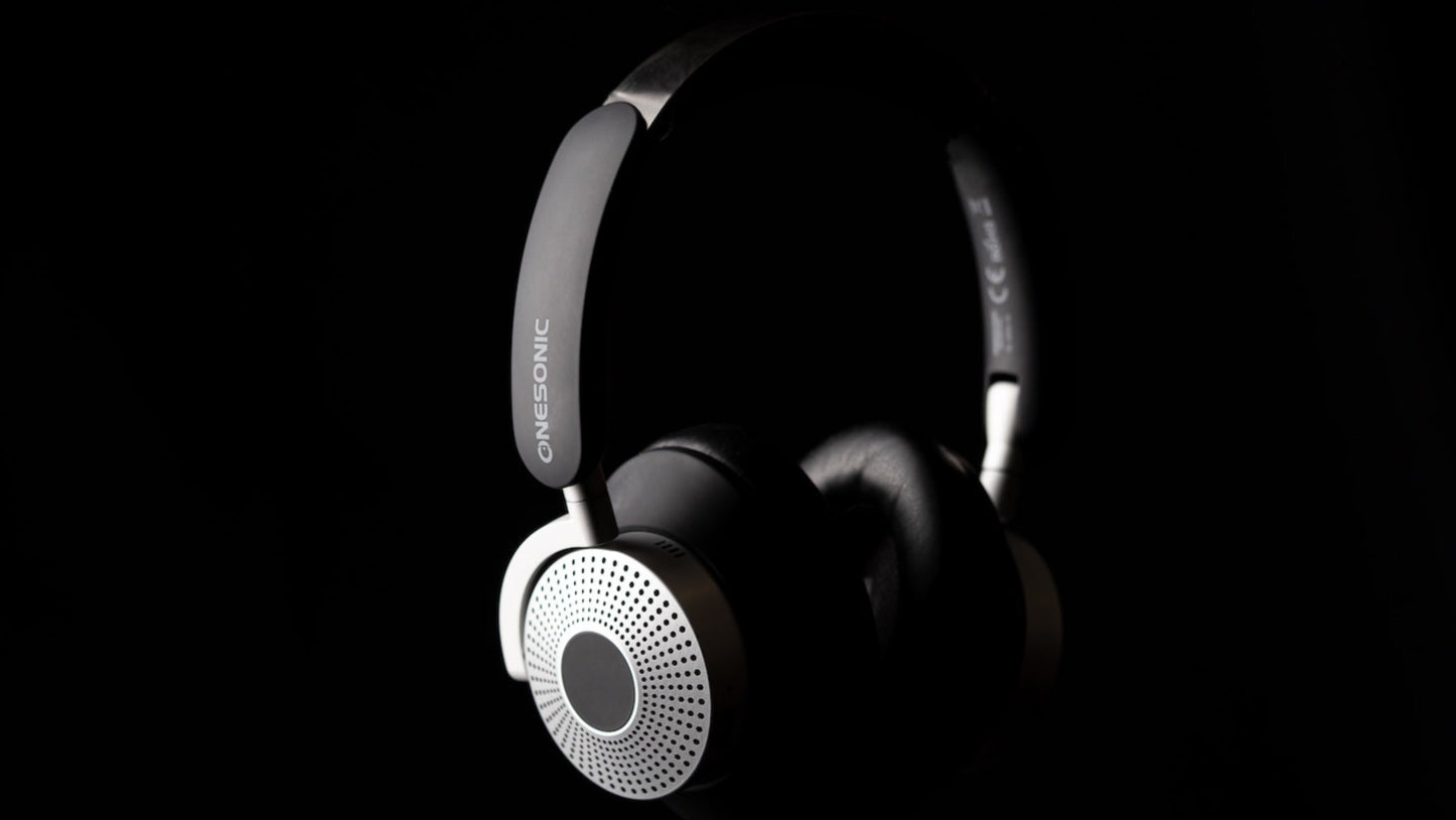 Black and white headphones on a black background